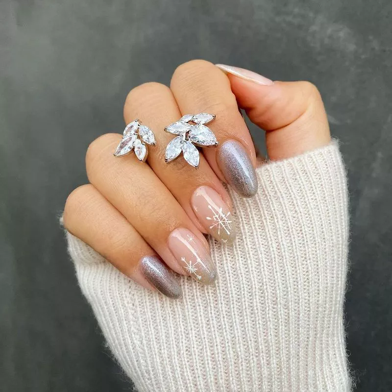 Pink and silver shimmer manicure with white snowflake nail designs