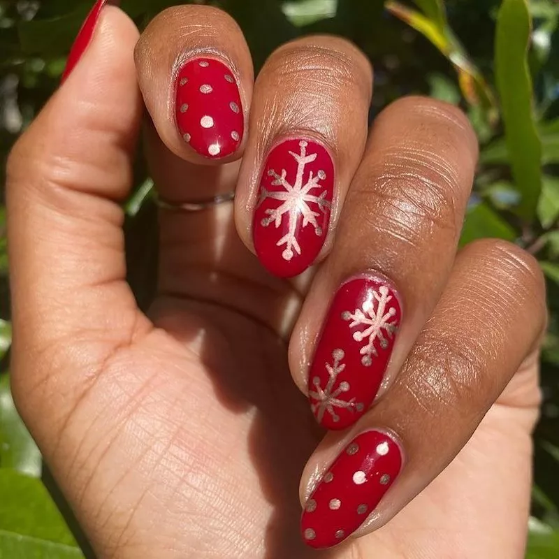 Red manicure with chrome snowflakes and dots