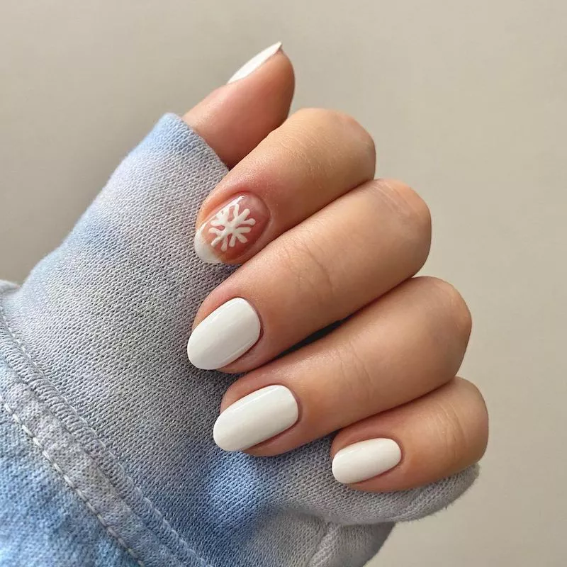 White manicure with a snowflake accent nail