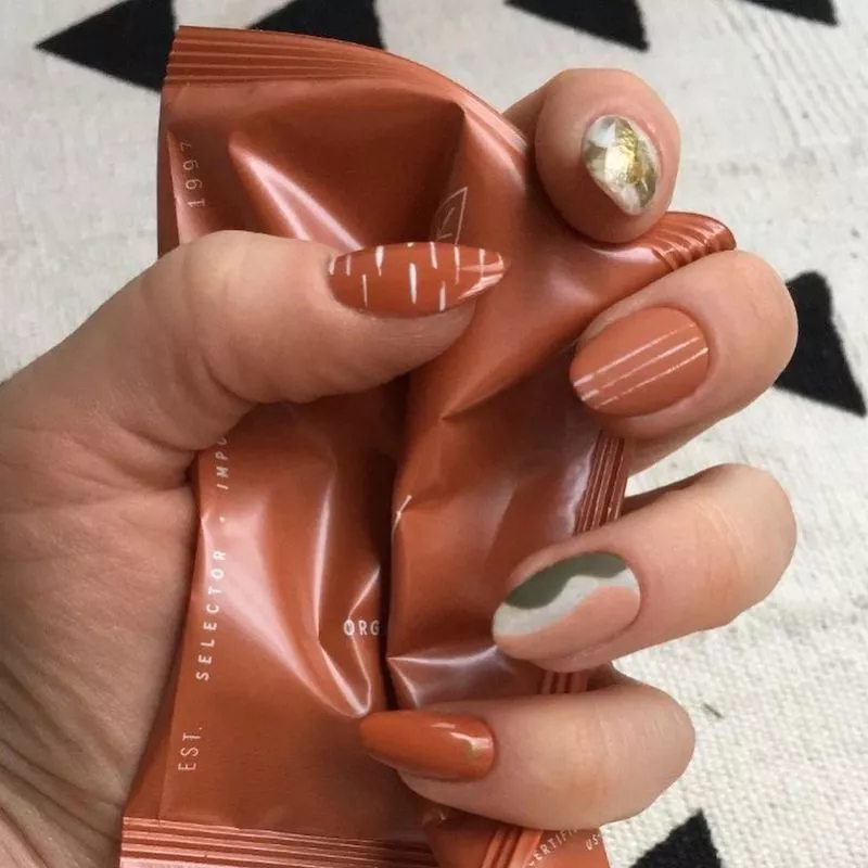Abstract nail art in terracotta color scheme