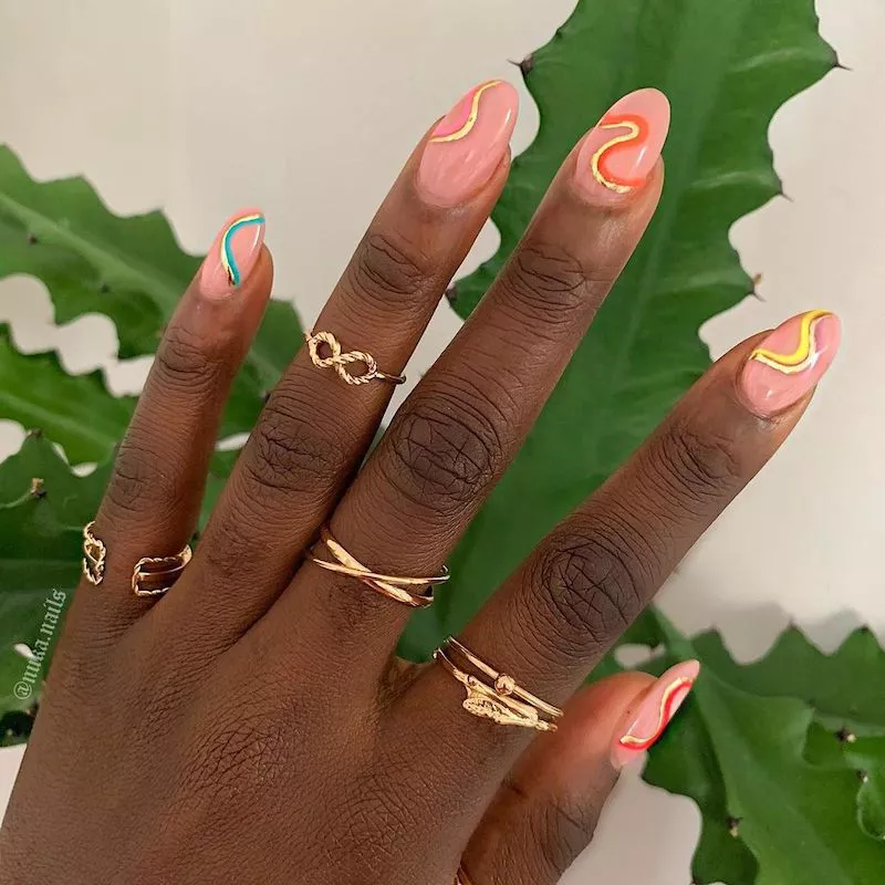 Peach manicure with abstract colorful wave designs