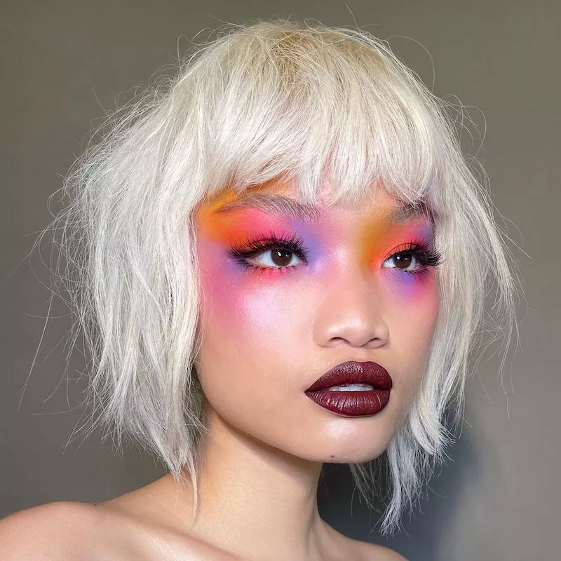 Model with sunset kaleidoscope eyeshadow and burgundy lipstick