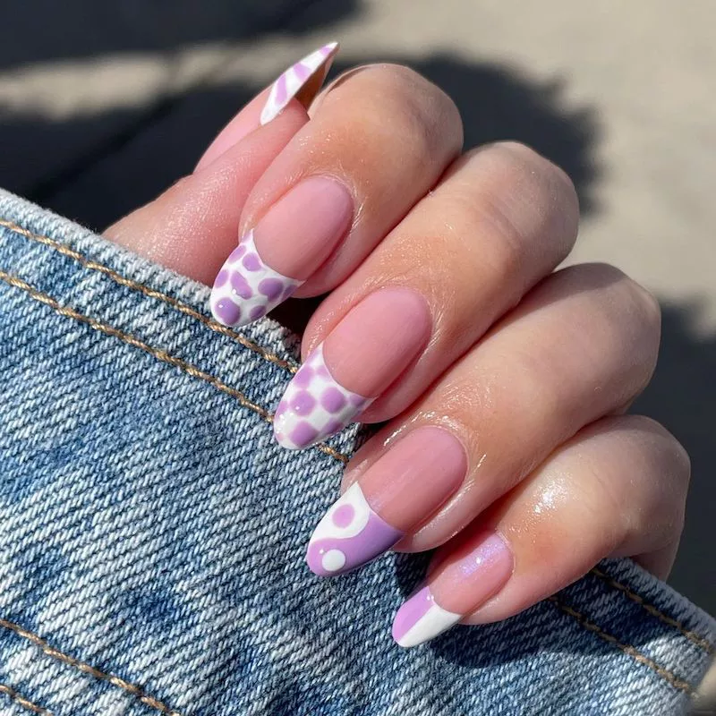 French manicure with pastel purple and white varied pattern tips