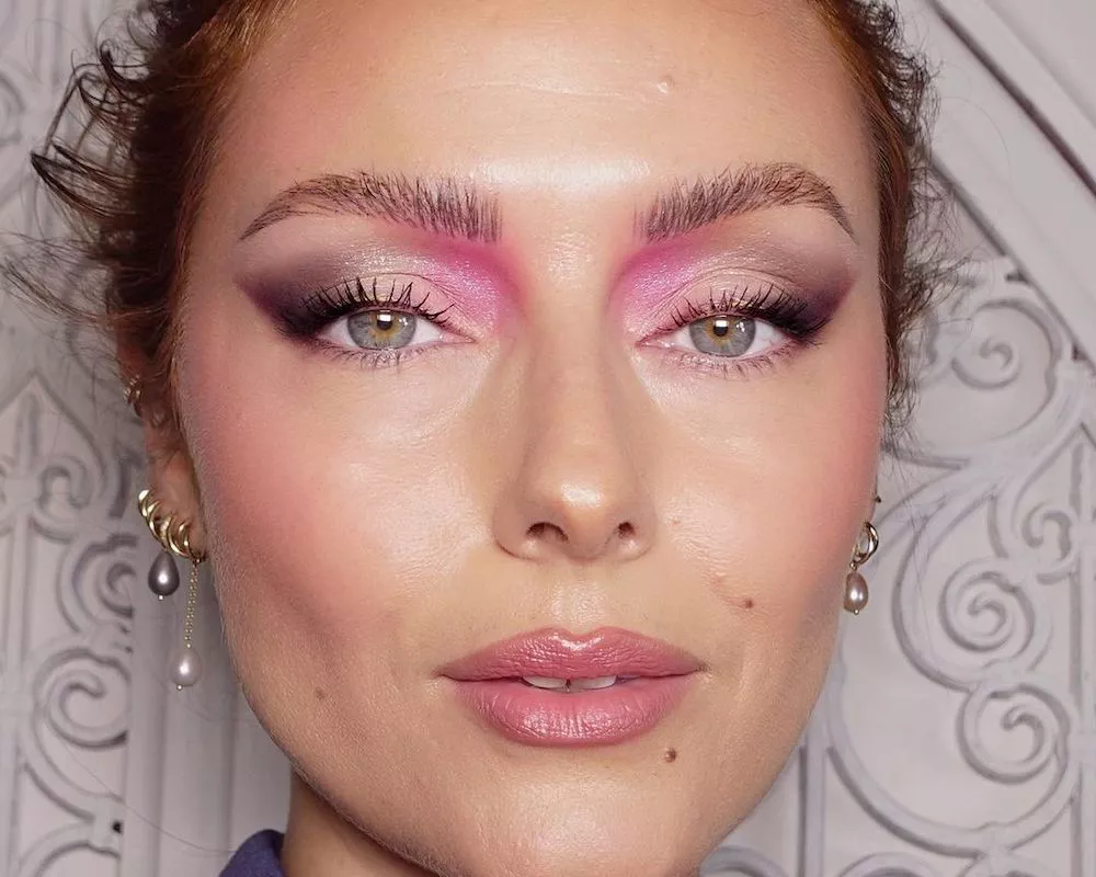 Katie Jane Hughes wears a shimmery pink, white, and black graphic eyeshadow look