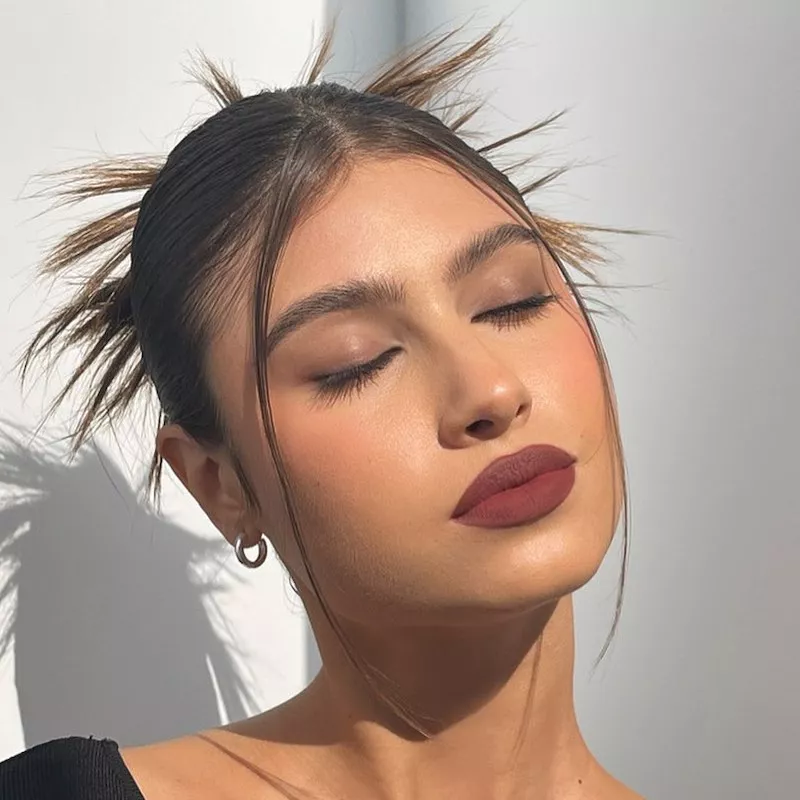 Model wears Makeup by Mario burgundy suede lipstick