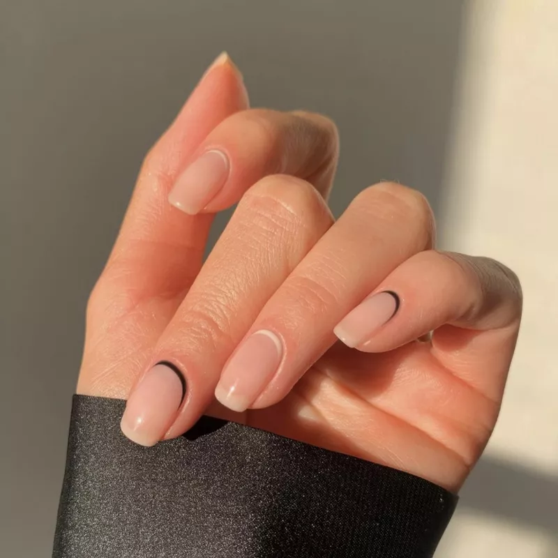 Nude nails with black and white inverted French design