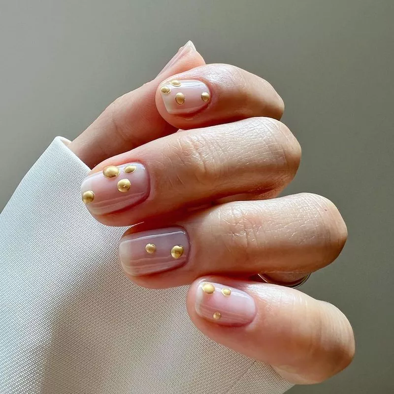 Clear nails with puffed gold dot design