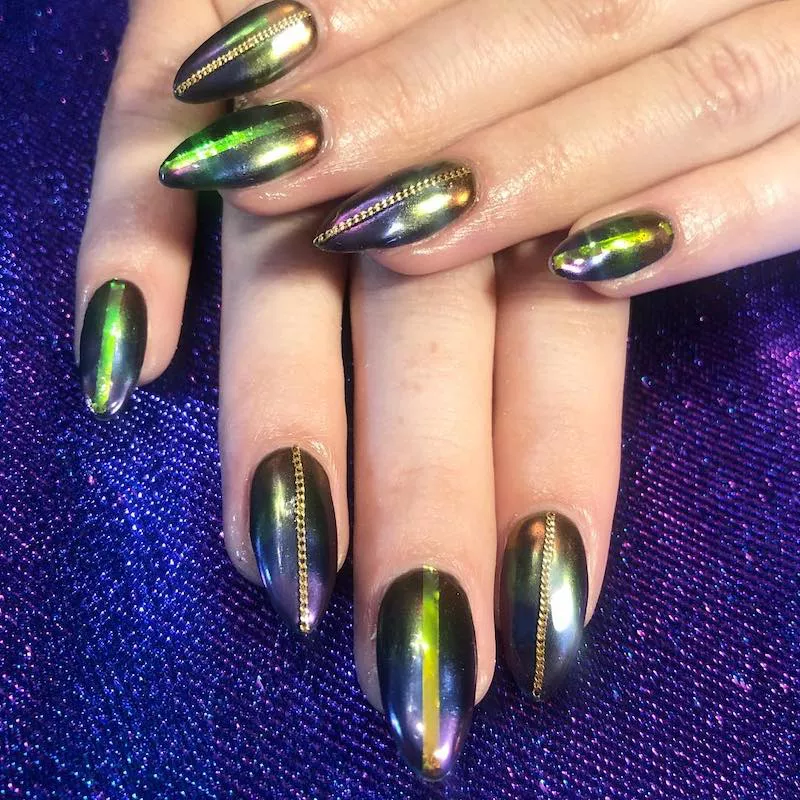 Almond-shaped nails with chrome polish and chain detail