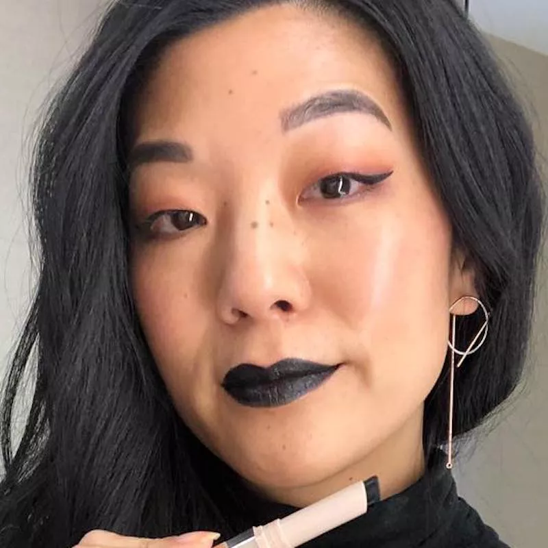 Michelle Lee wears Fenty Beauty black lipstick and winged eyeliner