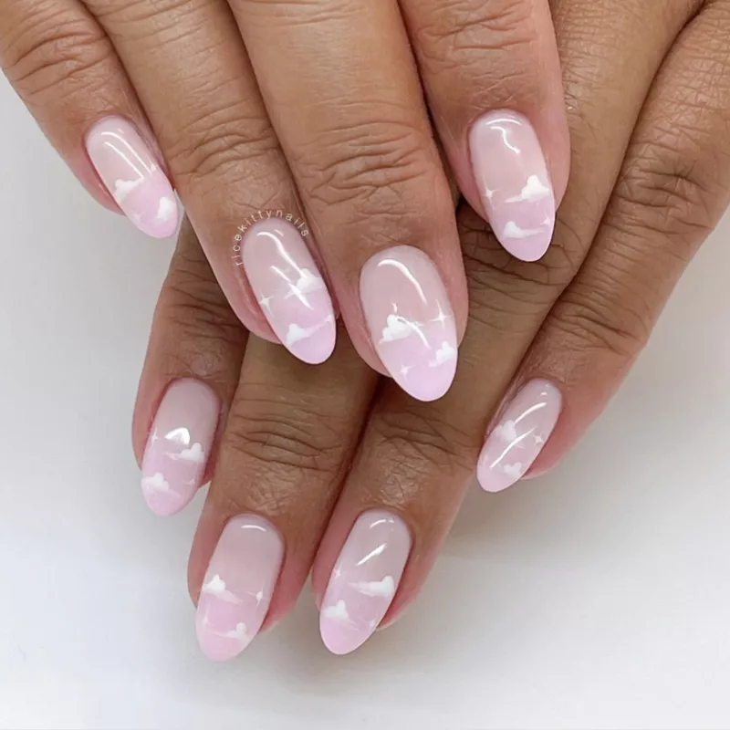 Pink nails with white cloud designs