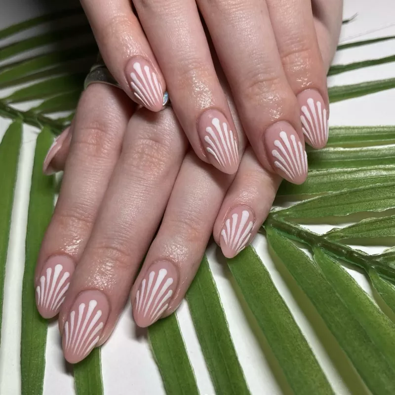 Latte-colored nails with white art deco line design