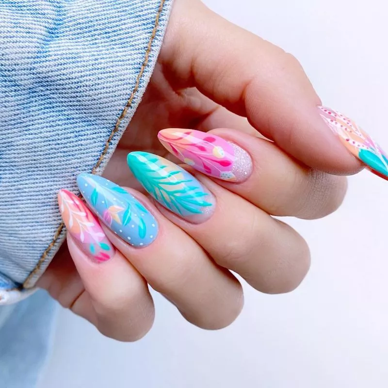 Almond-shaped nails with teal and pink plant designs