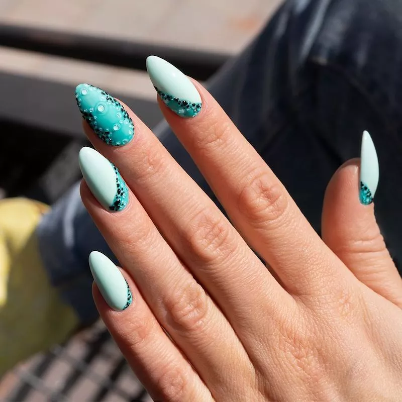 Teal almond-shaped nails with mermaid-inspired design