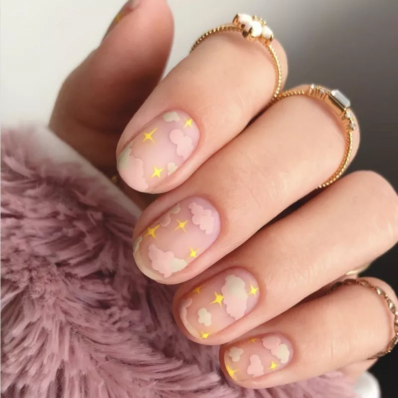 Pink cloud and yellow star nail design