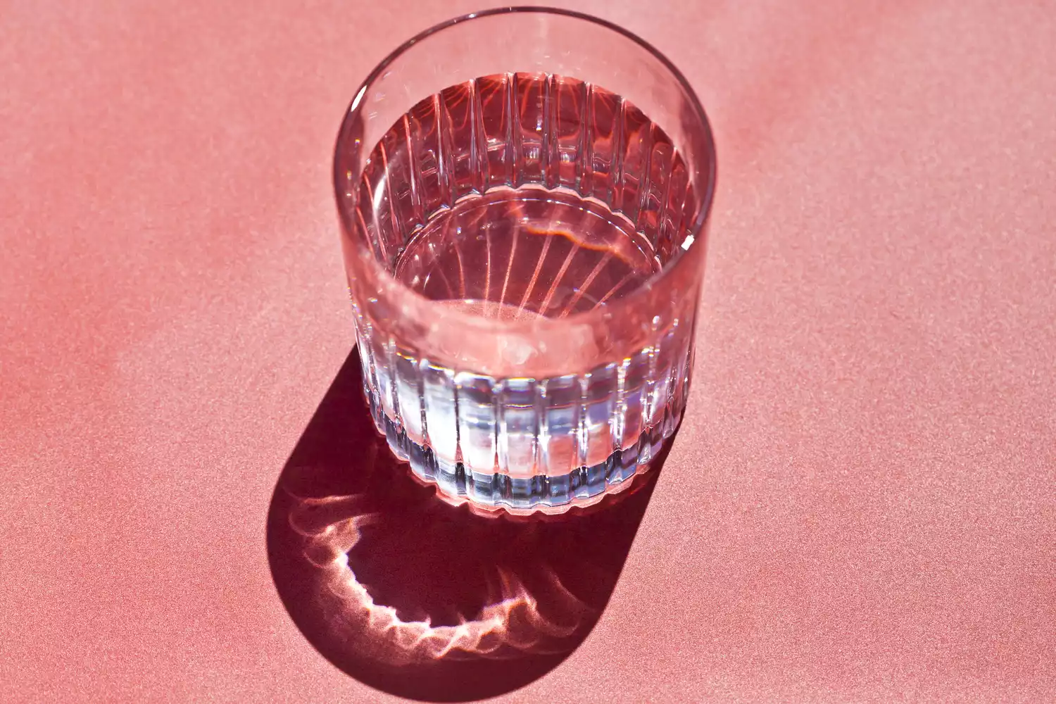 glass of water on pink background
