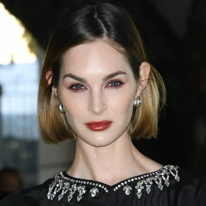 Laura Love wears a smoky plum eyeliner look at the Academy Museum Gala