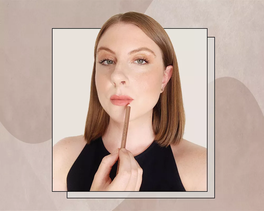 Woman Overlining her Lips to Achieve a Fuller Lip Look
