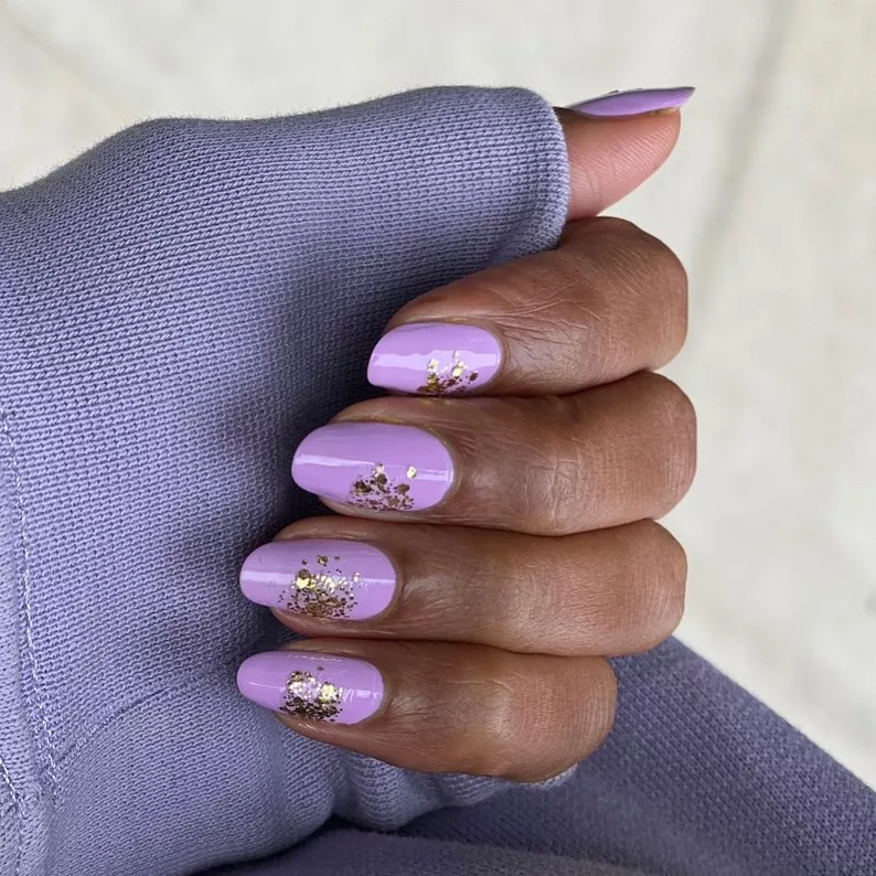 Person with pastel purple nails. 