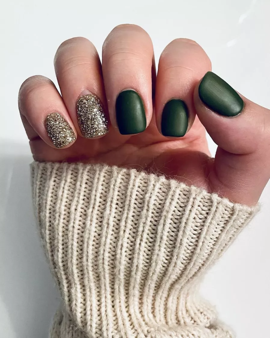 hand with matte green and sparkly dip powder nails