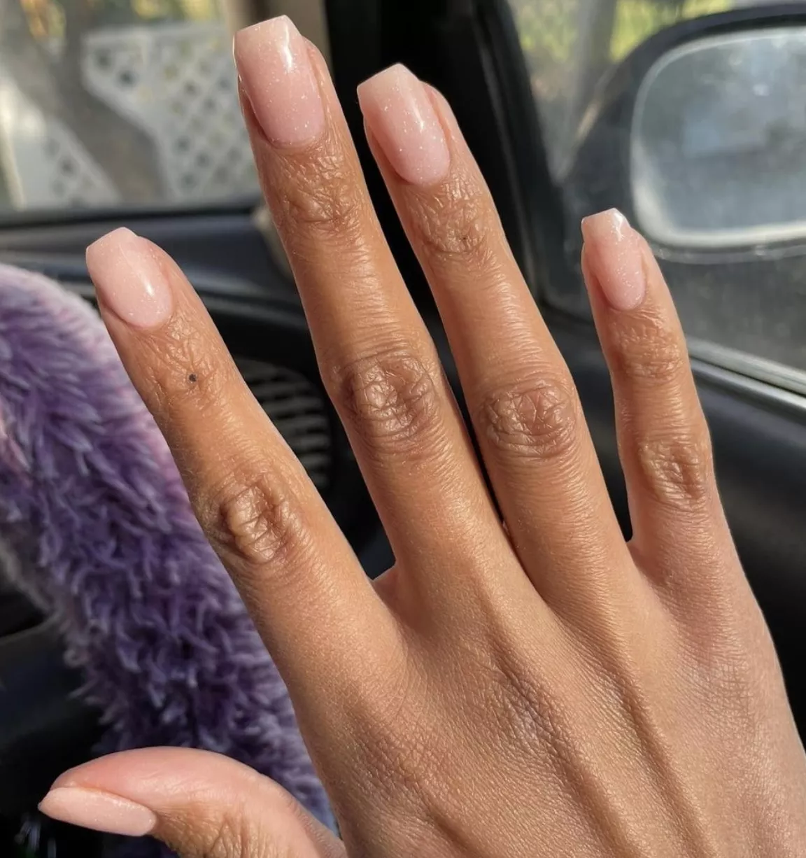 subtle peach colored shimmery dip powder nails