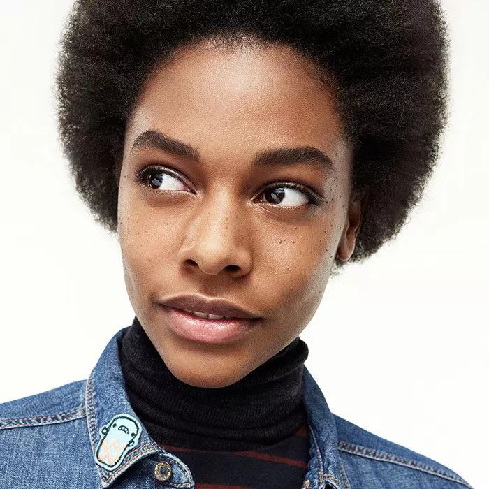 model with full brows in jean jacket