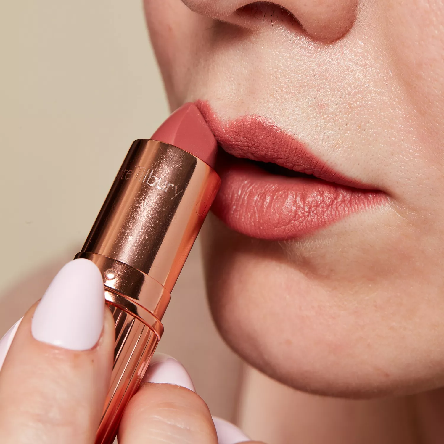 Close up of a woman applying lipstick