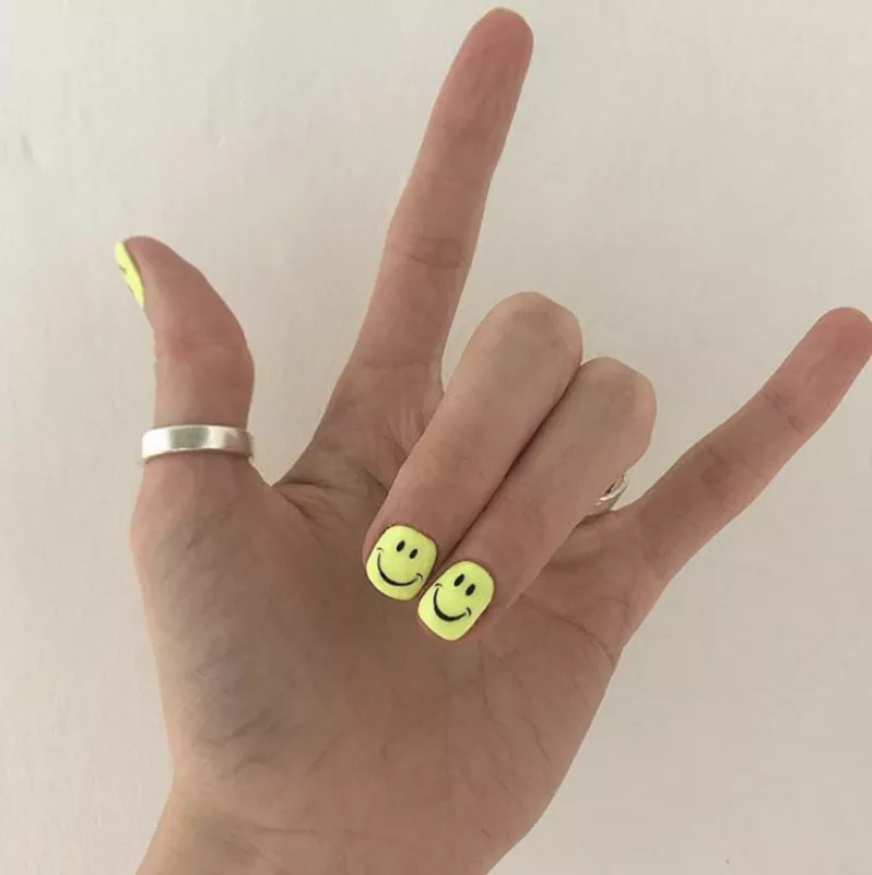 nails with yellow smiley faces