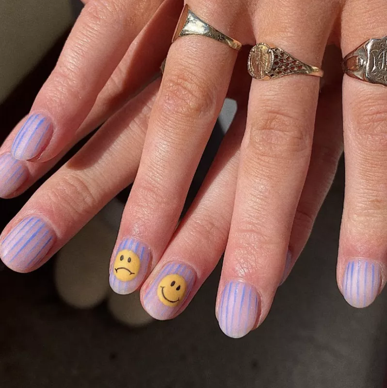 striped nails with smiley face and sad face