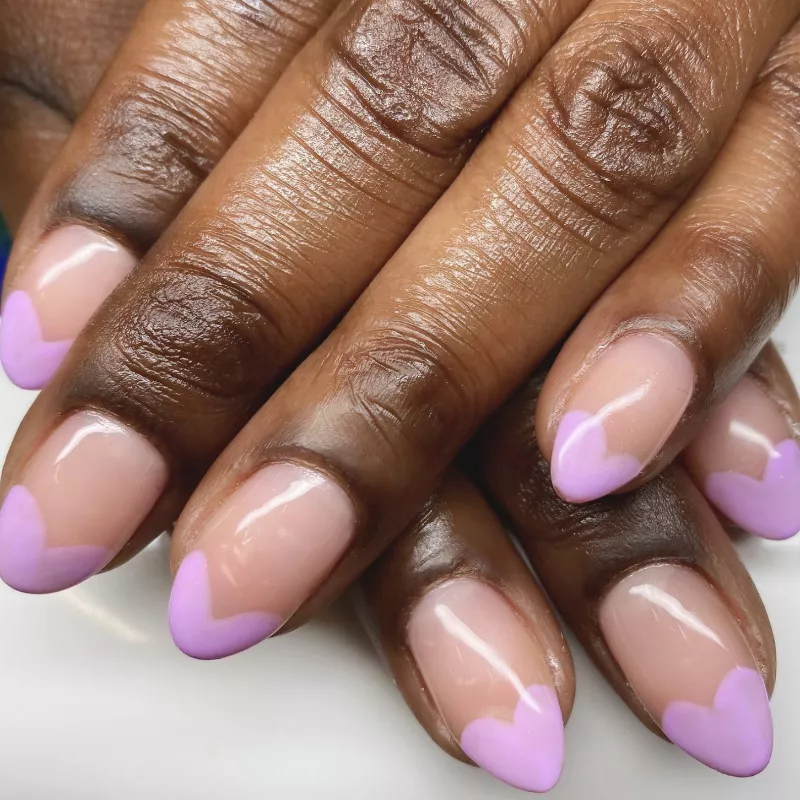 French manicure with pastel purple heart-shaped tips