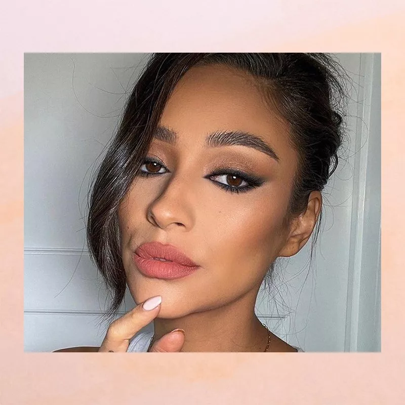 The actress Shay Mitchell in smokey winged liner