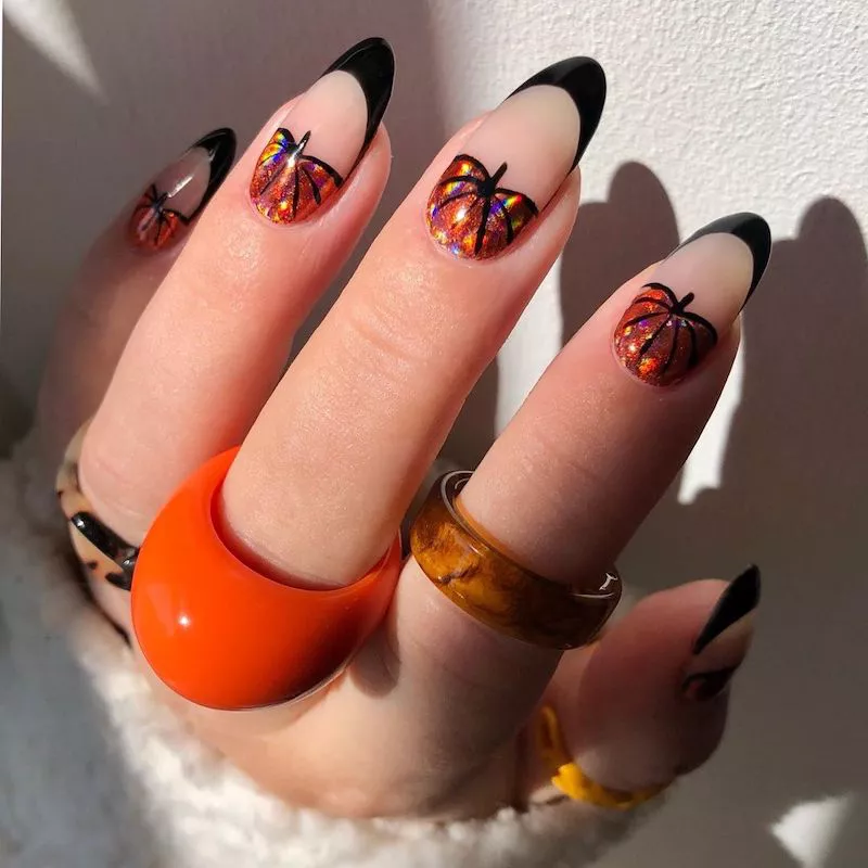 Black French manicure with iridescent blood orange pumpkin design at base