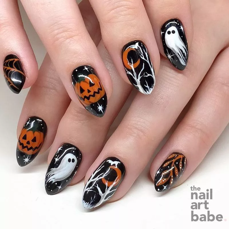 Black manicure with orange and white woods, ghost, web, and pumpkin nail designs