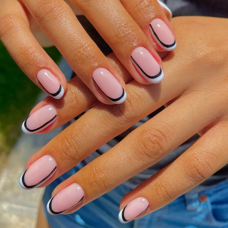 Double French manicure with pink base and black and white art deco tips