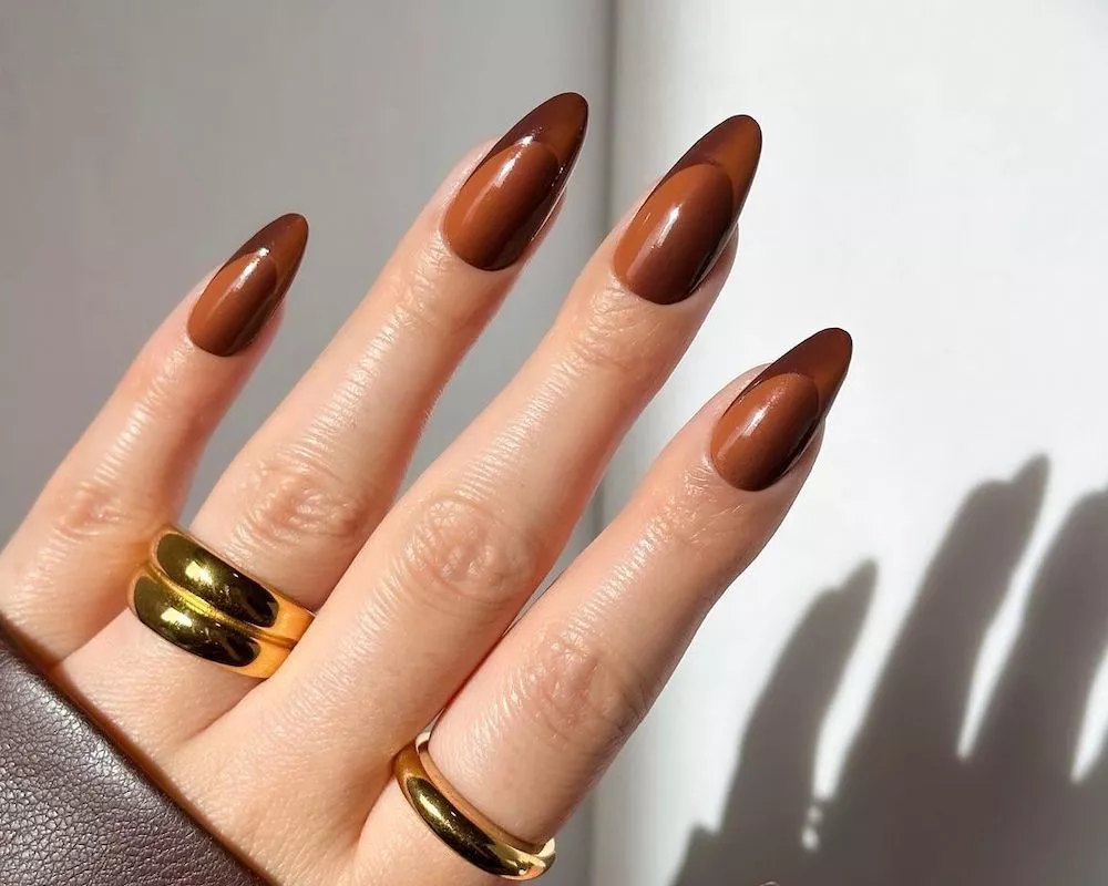 Two-toned brown French manicure with gold rings