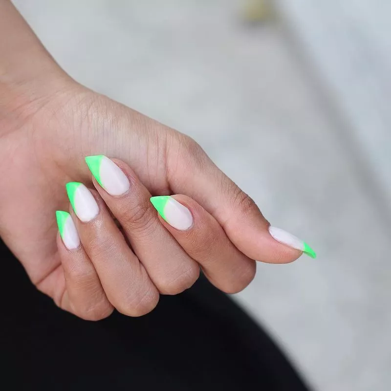 Lipstick shaped nails with white base and neon green tips