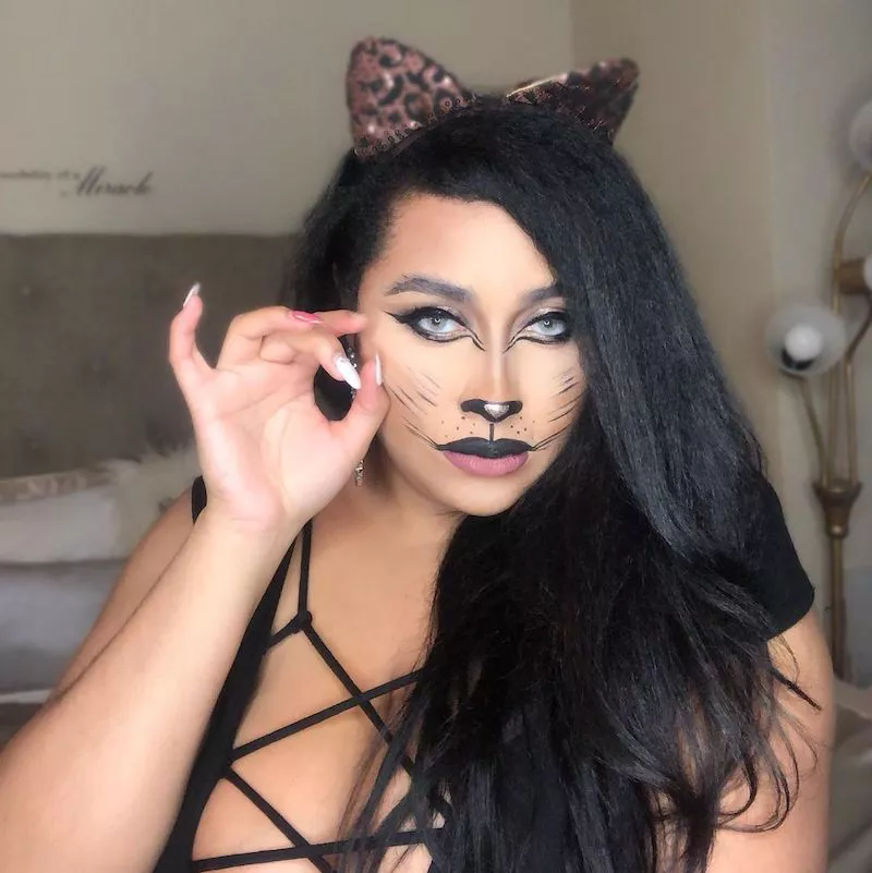 Woman with cat Halloween makeup look and leopard ears