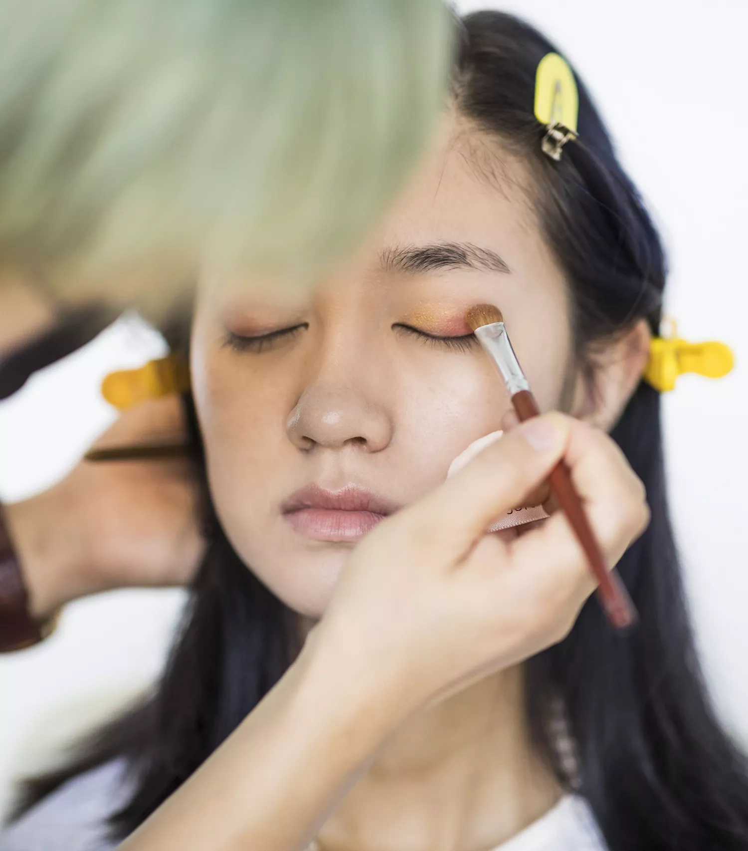Makeup artist applying smoky eyeshadow