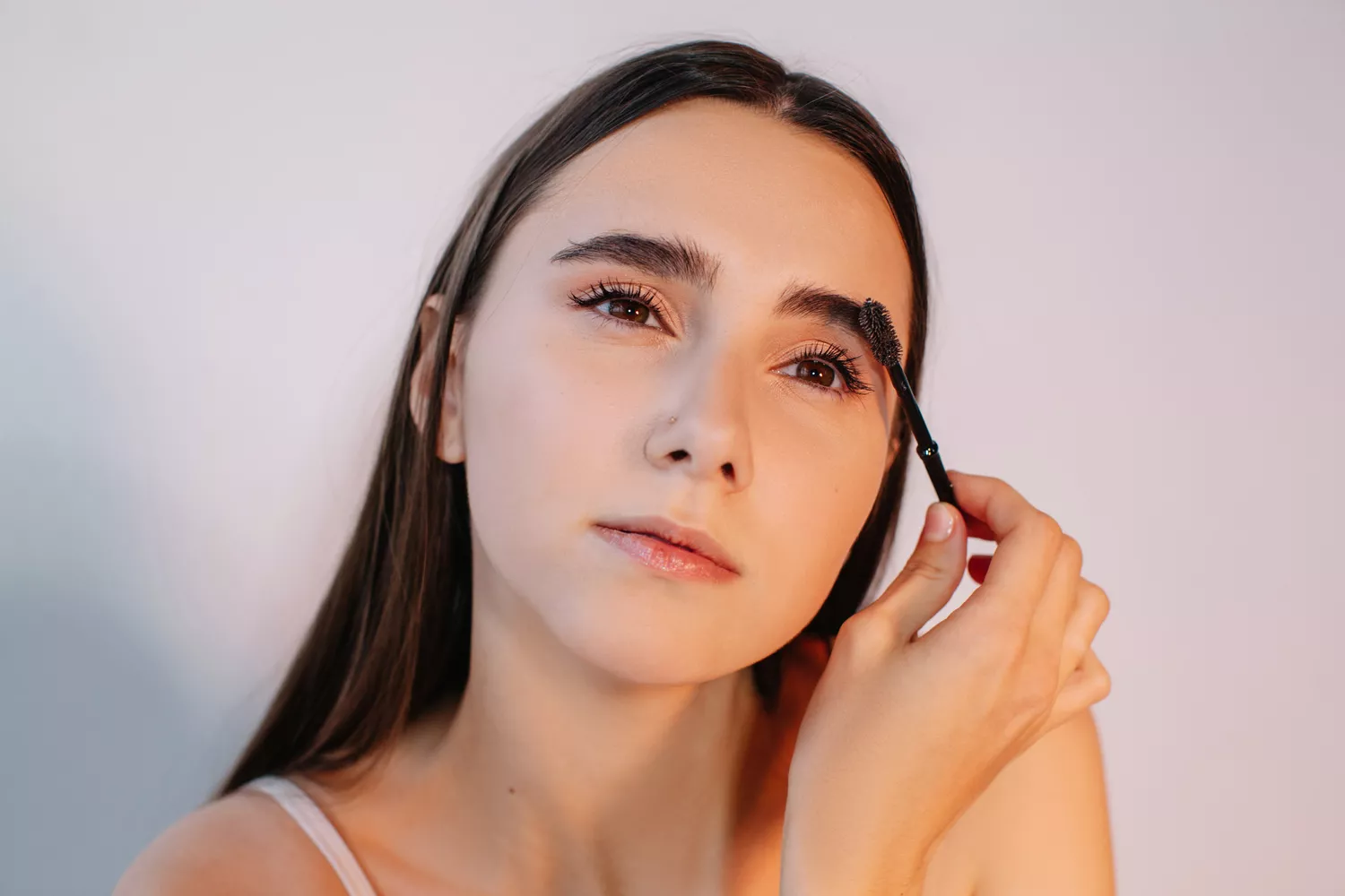 young woman doing her brows