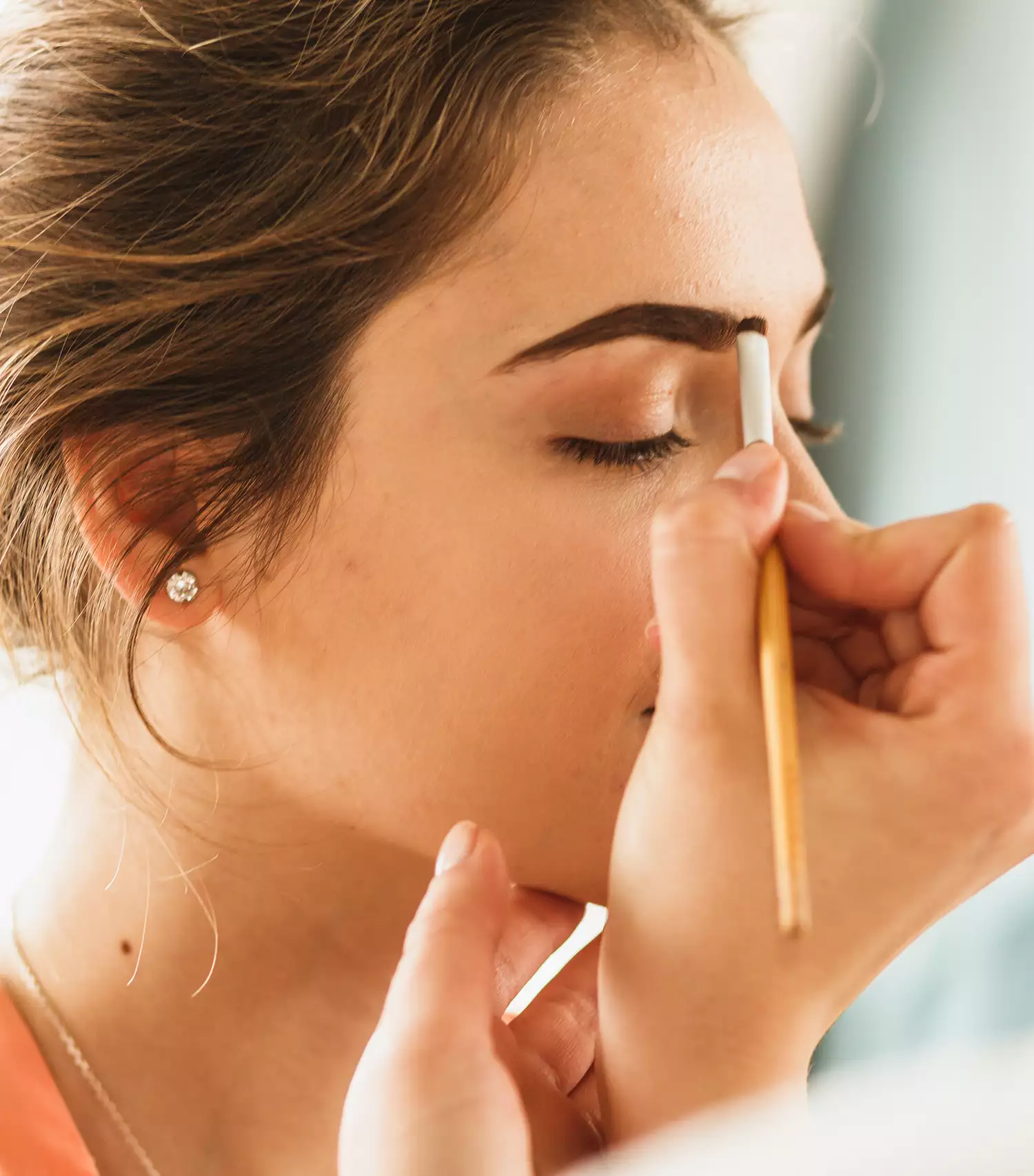 Makeup artist applying eyebrow makeup
