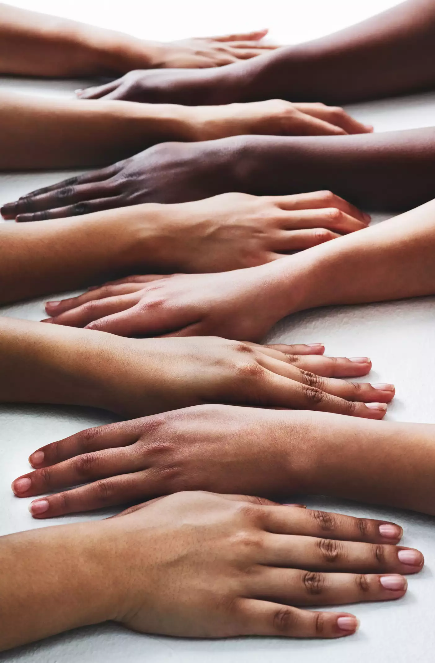 many hands of different skin tones