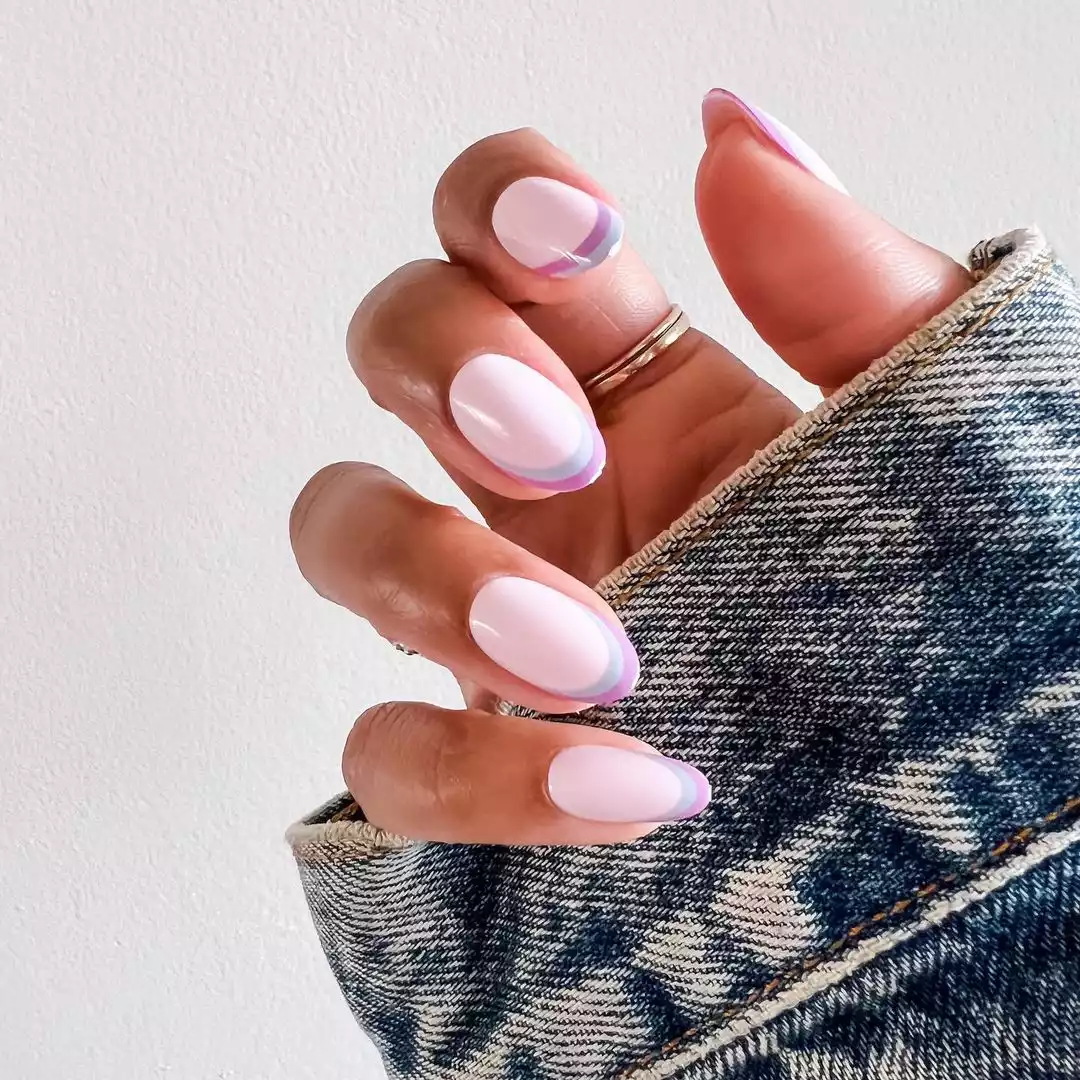 Pastel pink nails with pastel blue and purple double French tips