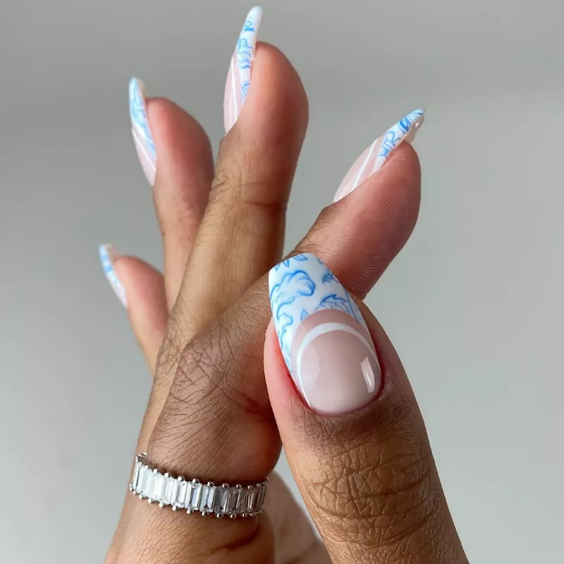 Double French manicure in pastel blue with bright blue toile design
