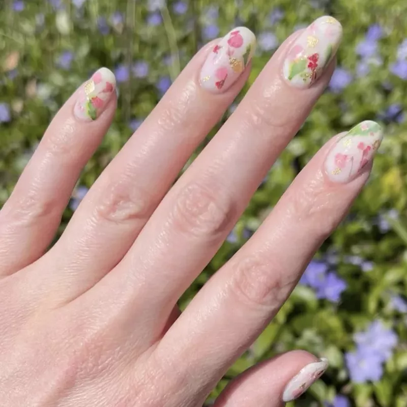 White milk bath nails with pink and red flowers