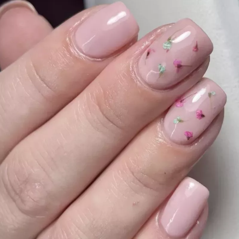 Pale pink milk bath nails with pink and green dried flowers