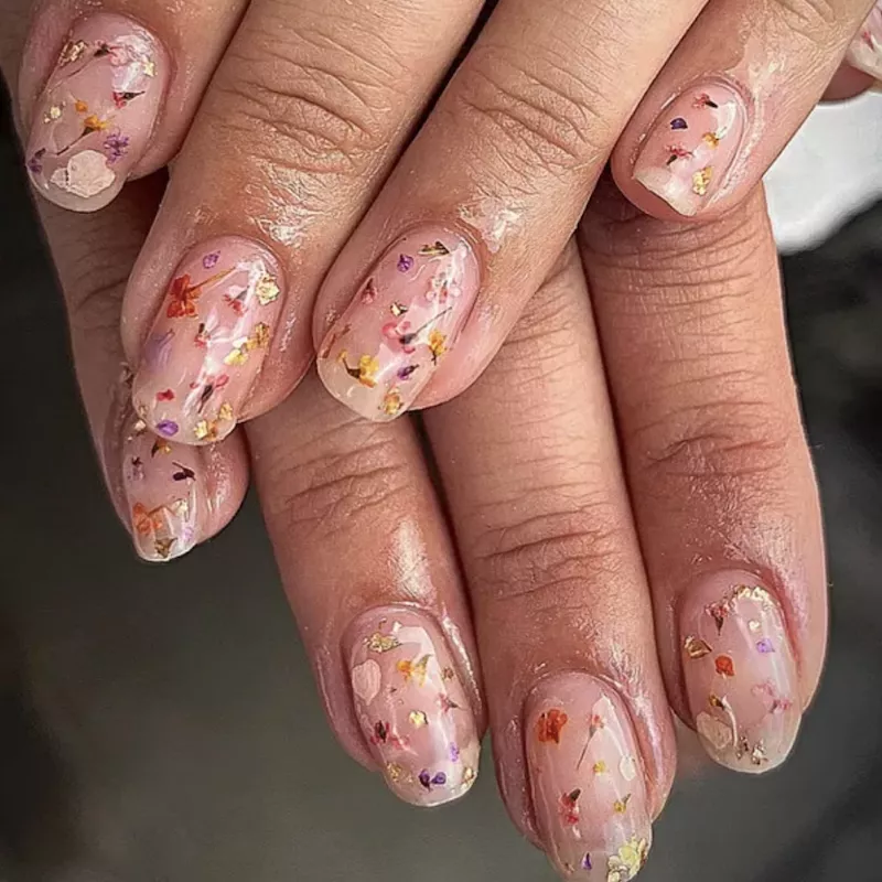 Milk bath nails with orange, yellow, and purple flowers and gold foil