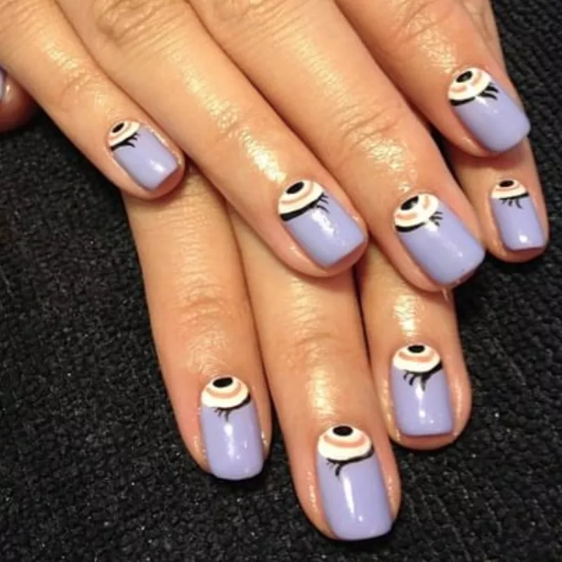 Periwinkle manicure with eye half-moon nail design
