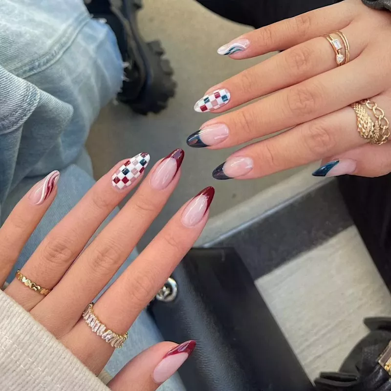Maroon, white, and navy blue French manicure with checkered and wavy accent nails