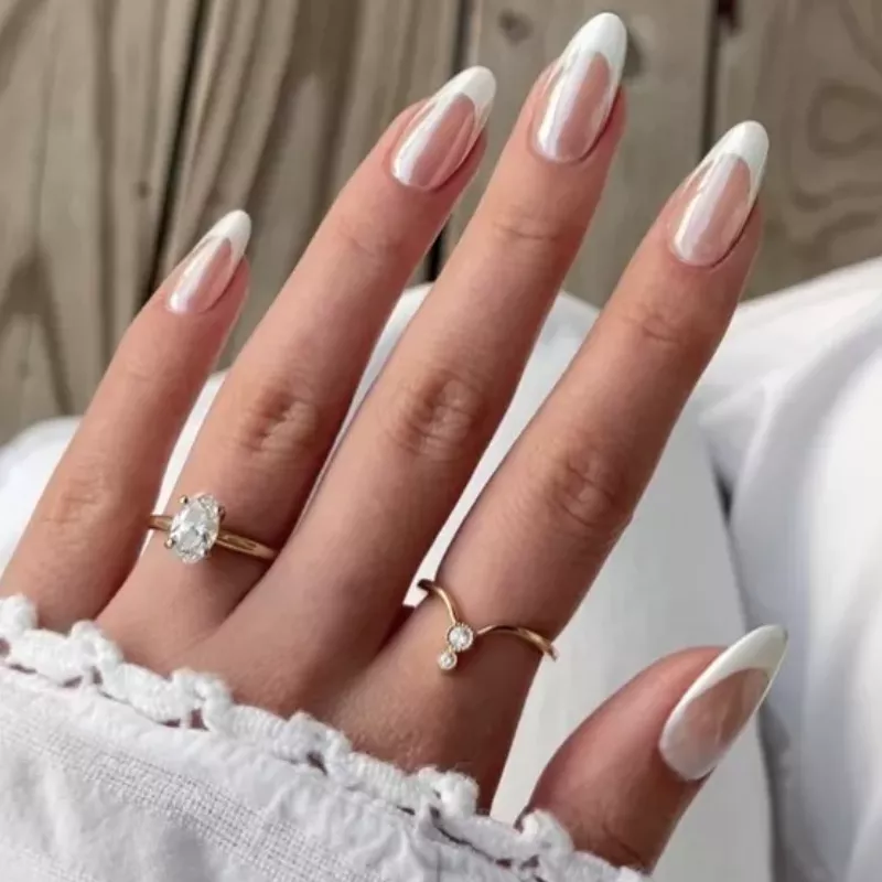 Chrome manicure with white French tips and gold rings