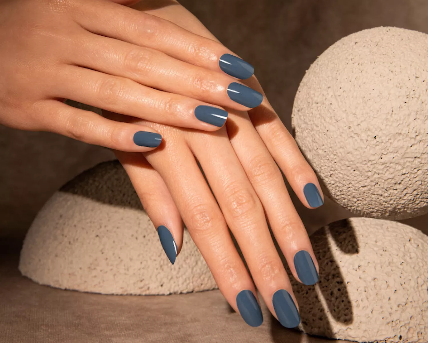 woman's hands with gray-blue manicure