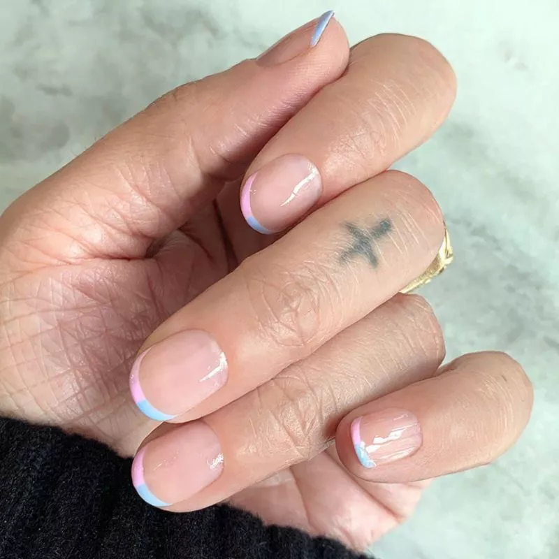 Baby French manicure with half-baby blue, half-bubblegum pink tips